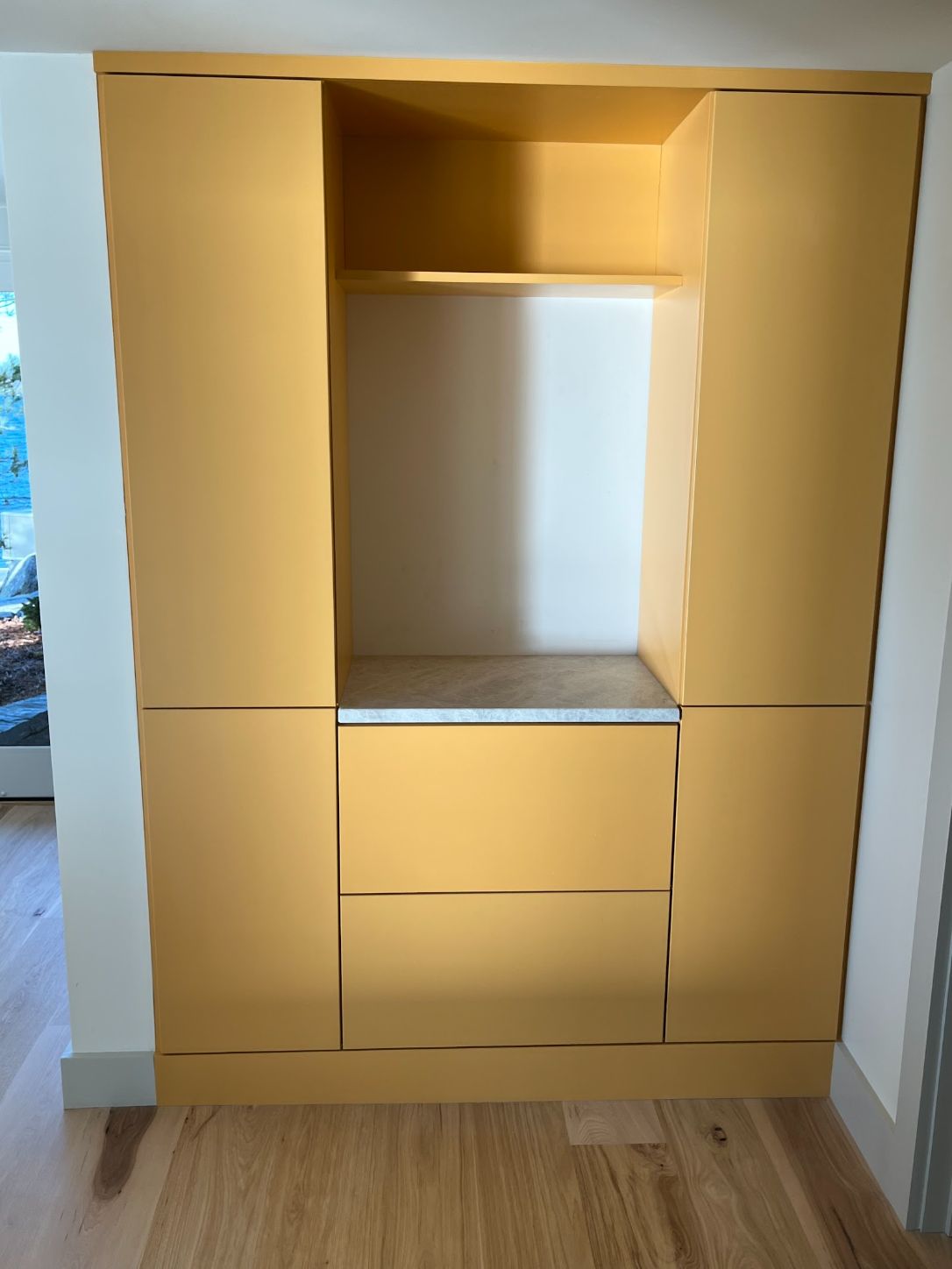 Gold-painted drop-zone cabinet with tall doors either side of an open niche over a bank of drawers