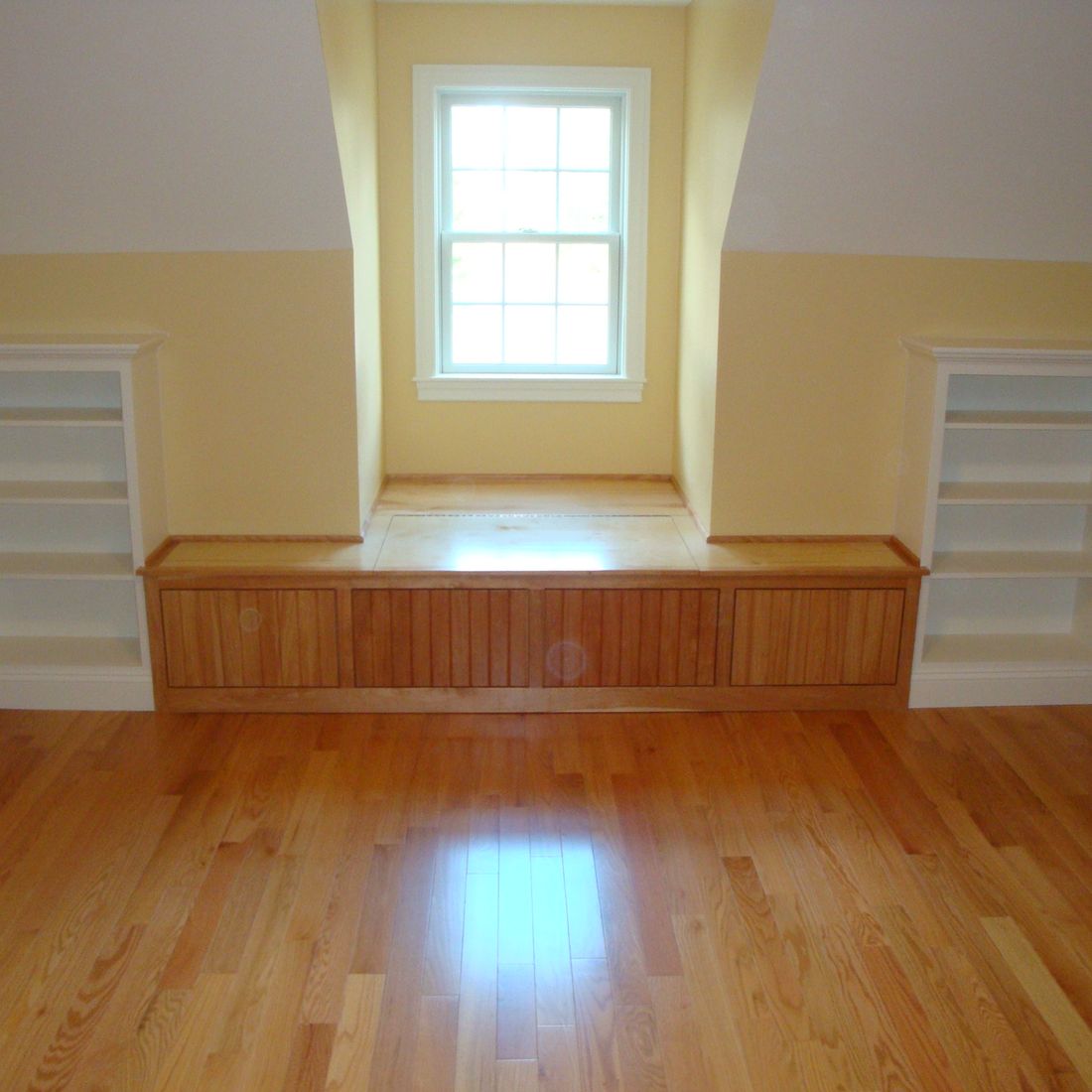 Built-in window seat with drawers below and flanking bookcases