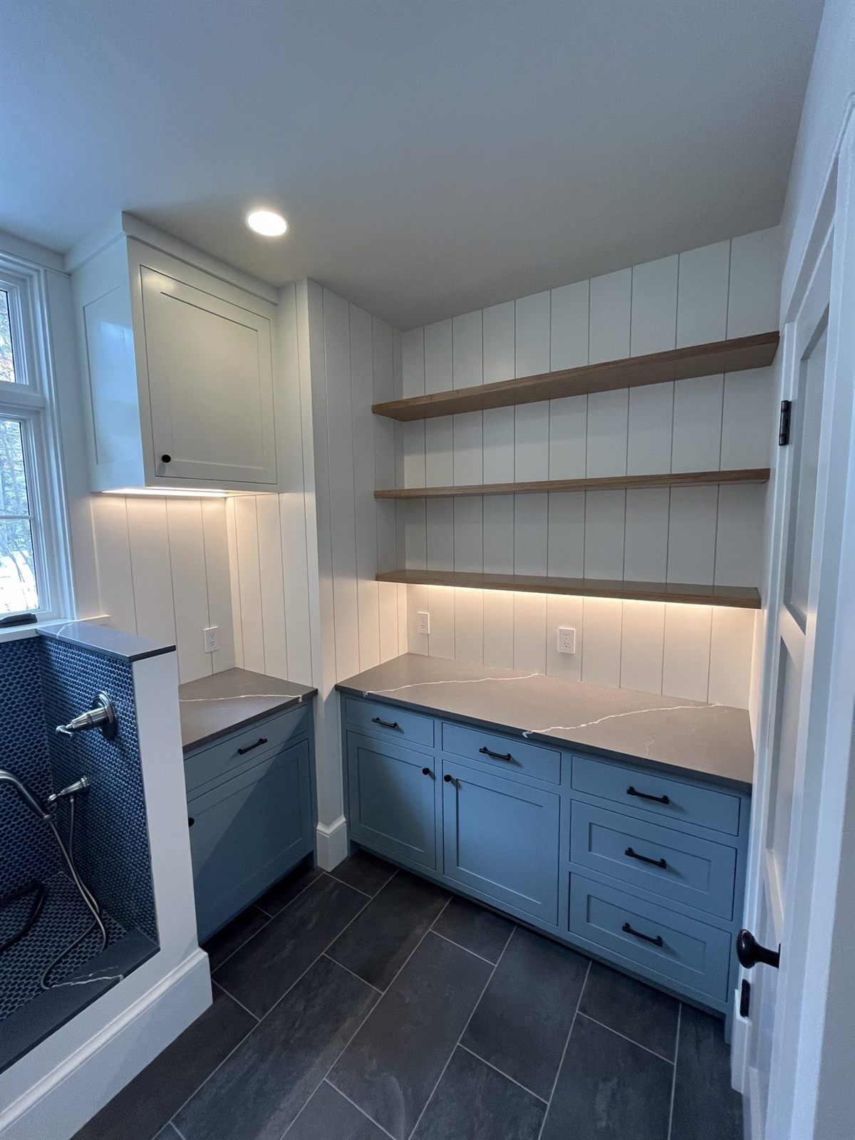 Butler's pantry with slate blue cabinetry, floating white oak shelves and shiplap walls